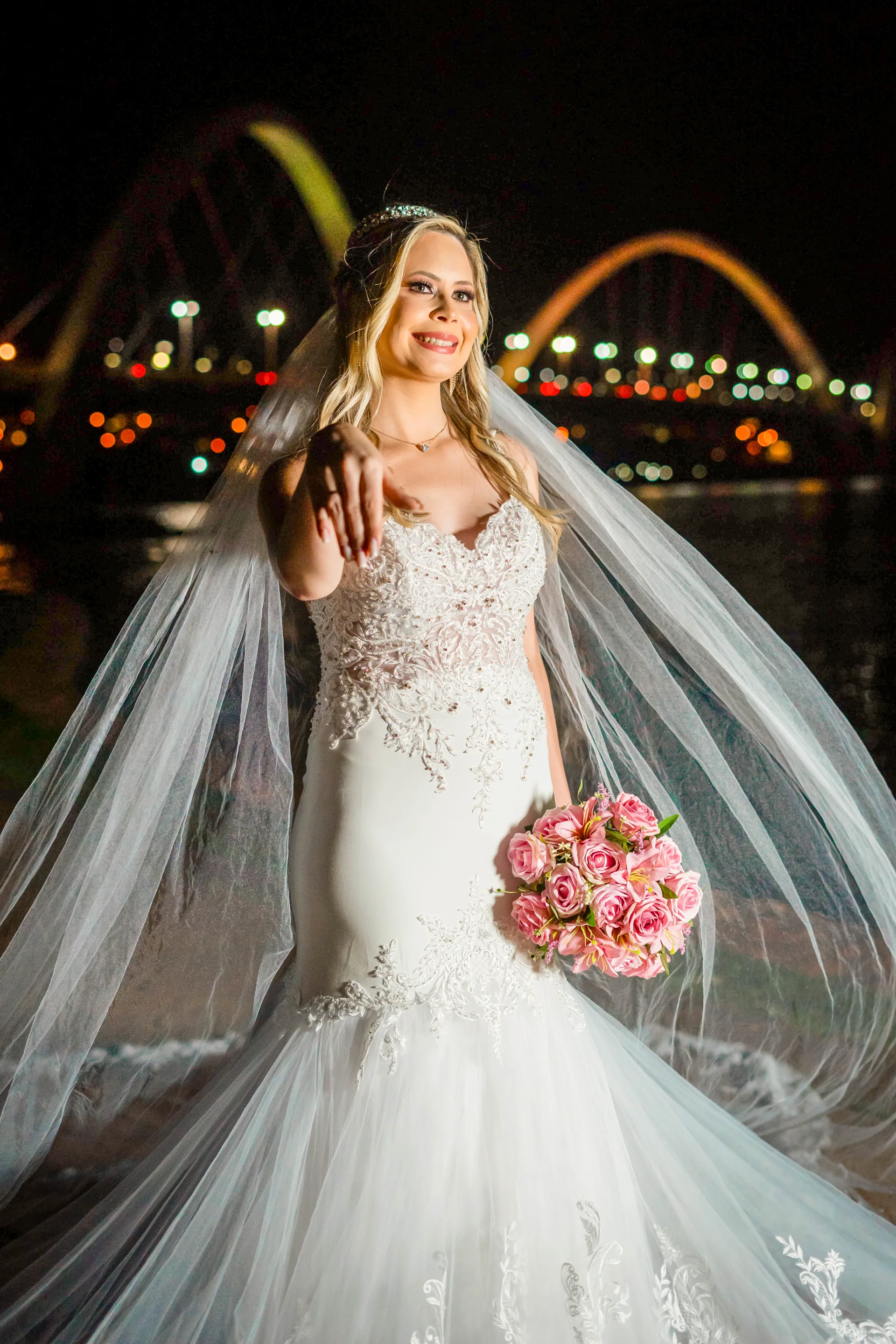 Retrato noturno de noiva com véu e buquê rosa