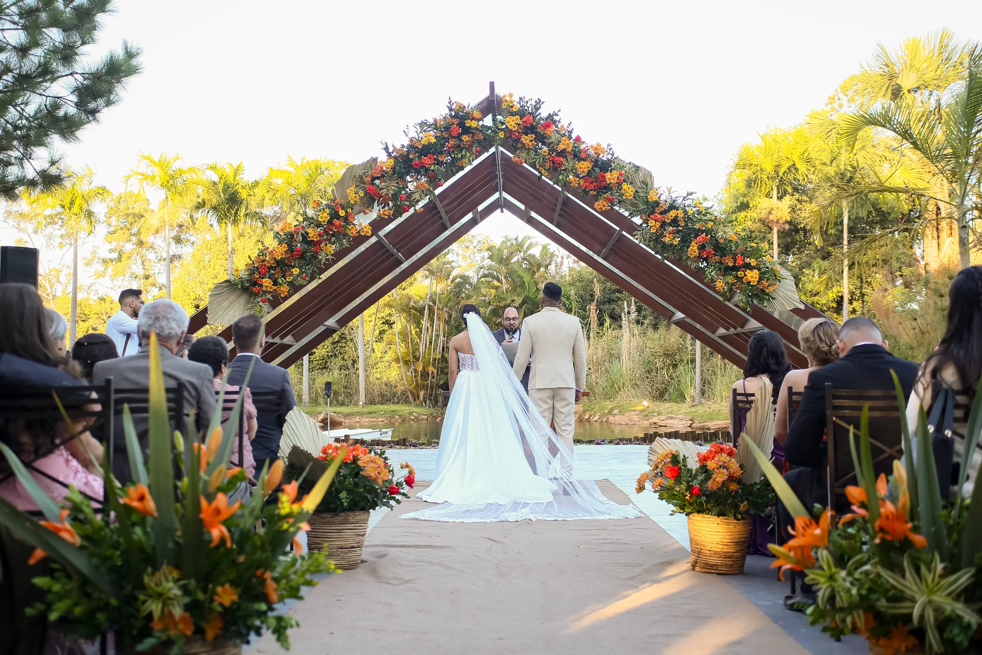 Cerimônia de casamento ao ar livre emoldurada por flores
